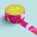 Colorful washi tape with a motivational quote on a light blue background